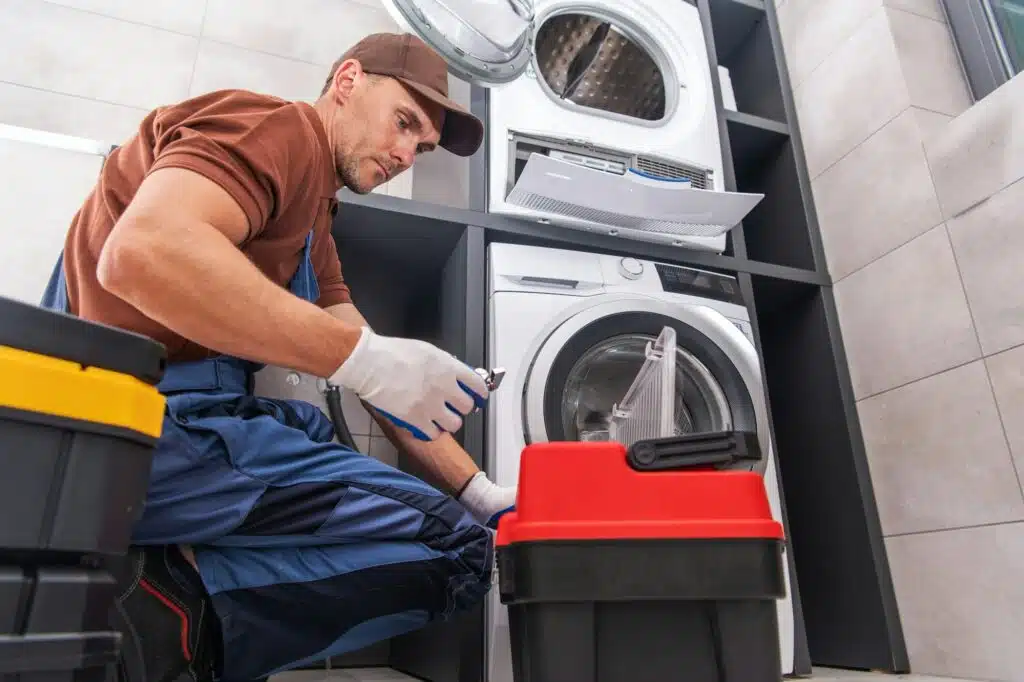 Handyman Repairing a Washing Machine