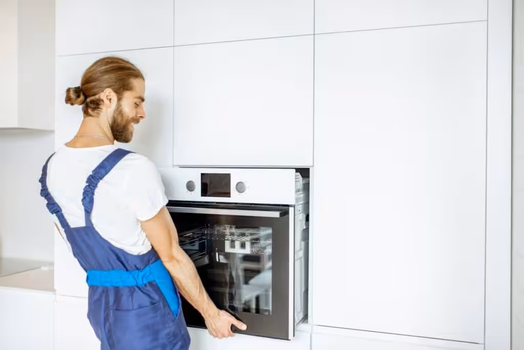 Workman installing kitchen oven